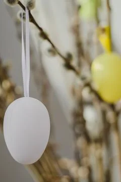 Fresh flowering branches decorated with easter colorful eggs in a vase. Holiday Stock-Fotos