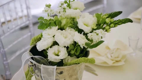 Fresh flowers are placed on a table in a metal bucket Stock Footage 344898810