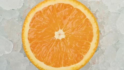 Fresh fresh orange slice over crushed ice Stock Footage 134820362