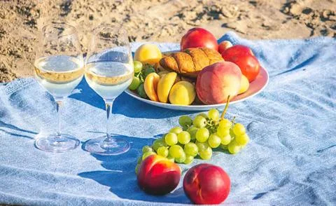 Fresh fruit and drinks on a beach picnic setup Stock Photos