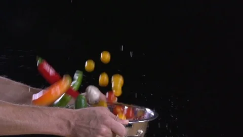 Fresh fruit and vegetables flying out of colander Water drops super Slow motion Stock Footage 80548093