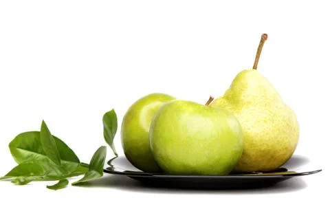 Fresh fruit. apples and pears on a plate isolated over white background. Stock Photos
