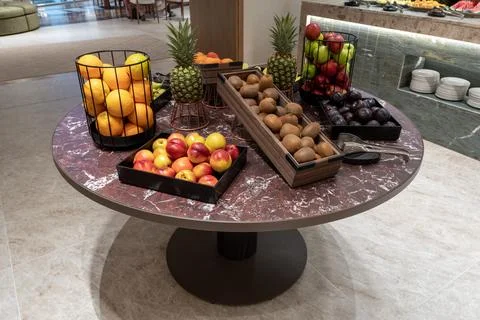 Fresh fruit assortment on round marble buffet table Stock Photos