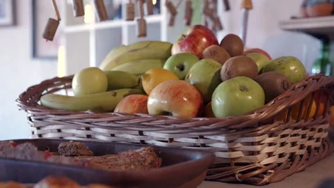 Fresh Fruit Basket on Rustic Kitchen Table with Natural Morning Light Vidéo 336668972