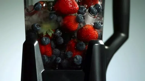 Fresh fruit blending inside an electric blender Stock Footage 327121951