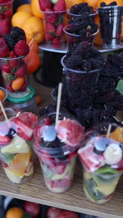 Fresh fruit cups with berries citrus and strawberries colorful snack Stock Footage 330904244