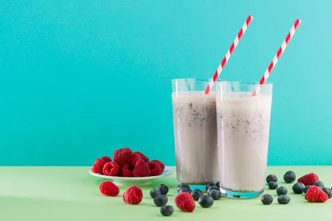 Fresh fruit drinks with berries on a table in a bright setting during daytime Stock Photos