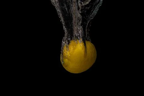 Fresh fruit fall into the cold water with air bubbles healthy vegan lifestyle Stock Photos