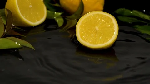 Fresh fruit lemon slice drops on water surface slow motion video Stock Footage 91504979
