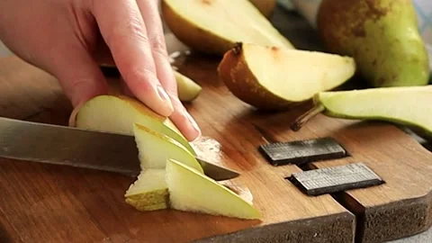 Fresh fruit pears are cut into pieces. Stock Footage 239467174