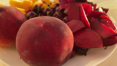 Fresh fruit on a plate in the evening light. Shooting with hands Stock-Footage 156285099