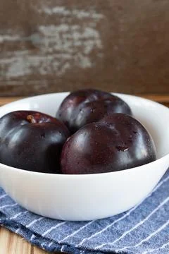 Fresh fruit plums on rustic background Stock Photos