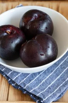 Fresh fruit plums on rustic background Stock Photos