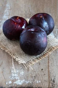 Fresh fruit plums on rustic background Stock Photos