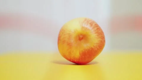 Fresh Gala Apple on Yellow Surface Minimalist Composition Stock Footage 345448182