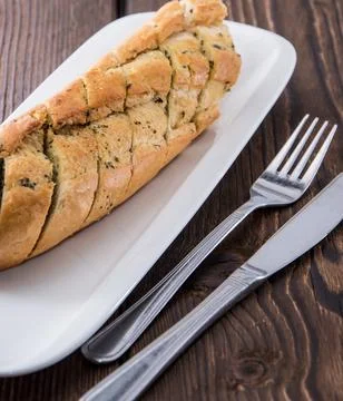 Fresh Garlic Bread with herbs on a plate Стоковые фото
