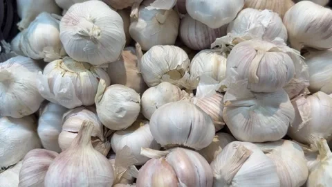 Fresh garlic bulbs in a rustic basket with textured skins Stock Footage 314098163