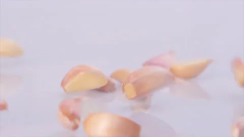 Fresh garlic fall on the table. On a black background Video stock 143120692