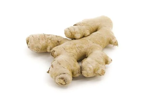 Fresh ginger arranged on smooth white background. Stock Photos
