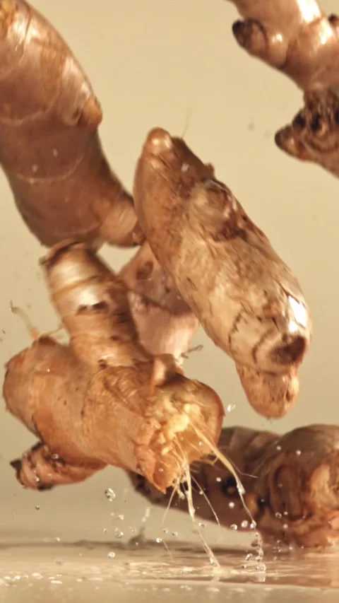 Fresh ginger falls on a bright table. Filmed on a high-speed camera at 1000 fps Stock Footage 335374082