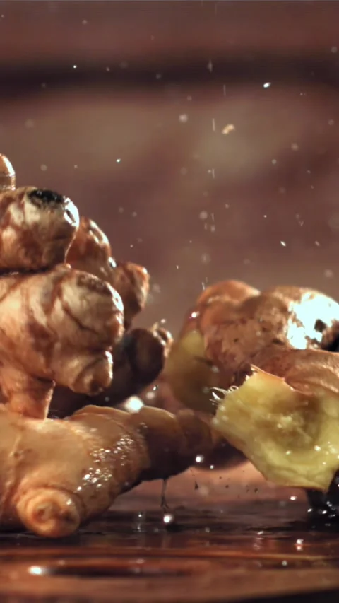 Fresh ginger falls on the table. Filmed on a high-speed camera at 1000 fps Stock Footage 335321639