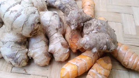 Fresh Ginger Red Ginger and Whole Turmeric on Bamboo Mat Stock Footage 340538092