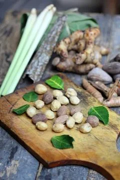 Fresh ginger root and peanuts on a wooden chopping board Stock Photos