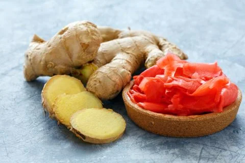 Fresh ginger root and pickled ginger slices. Stock Photos