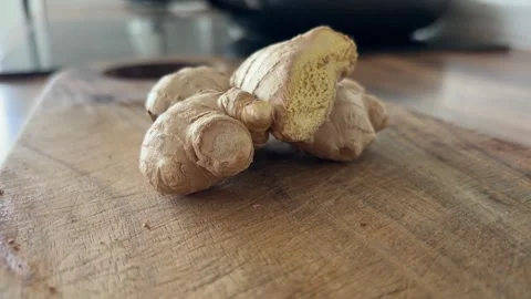 Fresh Ginger Root Close Up on Wooden Kitchen Table for Cooking Stock Footage 340395777