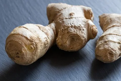 Fresh ginger root on a dark background Stock Photos