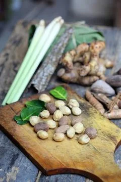 Fresh ginger root with garlic and green onion on wooden board Stock Photos