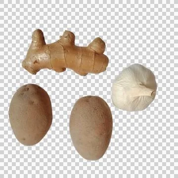 Fresh ginger root with garlic cloves and oval brown nuts arranged for cooki.. Фото