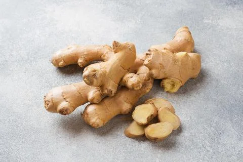 Fresh ginger root on grey background. Copy space. Stock Photos