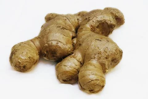 Fresh ginger root isolated on a white background in close up Stock Photos