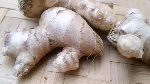 Fresh ginger root on natural bamboo mat background Stock Footage 340538369