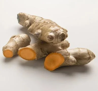 Fresh ginger root with sliced pieces on white background Stock Photos