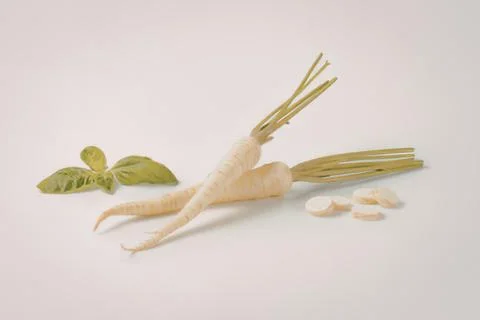 Fresh ginger root with sliced pieces and leaves Stock Photos