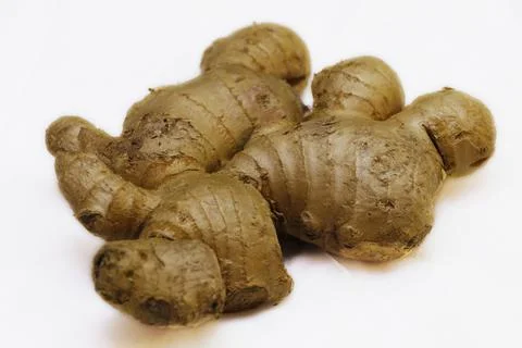 Fresh ginger root on a white background in close up Stock Photos