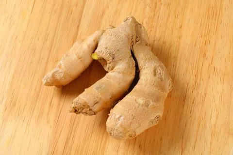 Fresh ginger root on wooden surface Stock Photos