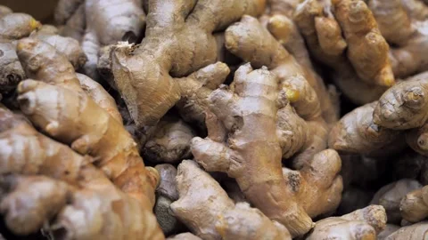 Fresh ginger roots displayed highlighting their earthy texture and aroma Stock Footage 297550949