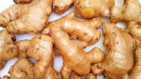 Fresh ginger roots or ginger rhizome rotating on white background, top view Stock Footage 310998502
