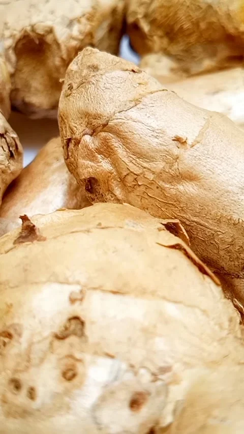 Fresh ginger roots or ginger rhizome rotating on white background, closeup,.. Stock Footage 310999433