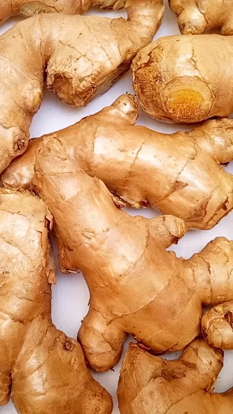 Fresh ginger roots or ginger rhizome rotating on white background, top view.. Stock Footage 310999618