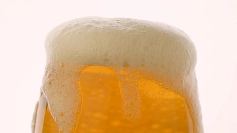Fresh glass of beer with foam over white background Stock Footage 101801971