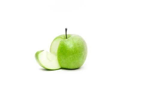 Fresh Granny Smith Apple with a slice apart from it Stock Photos