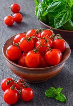 Fresh grape tomatoes with basil Stock Photos