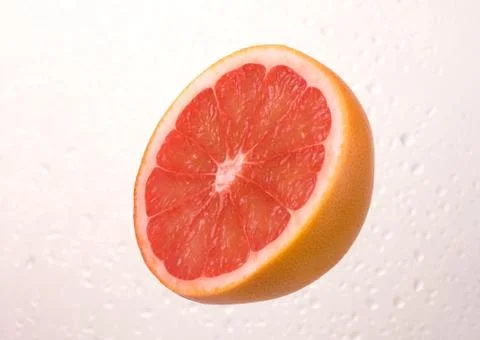 Fresh grapefruit on dewy background Stock Photos