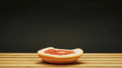 Fresh grapefruit growing up from cutting board. Stop Motion Animation Stock Footage 87833703