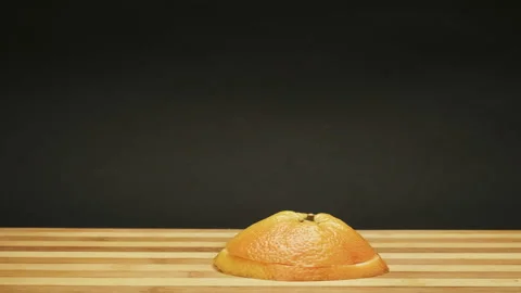 Fresh grapefruit growing up from cutting board. Stop Motion Animation Stock Footage 87834158