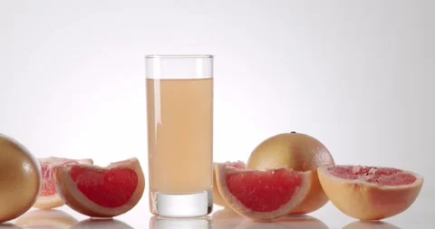 Fresh grapefruit juice with fruit slices isolated on white background Stock Footage 342740967